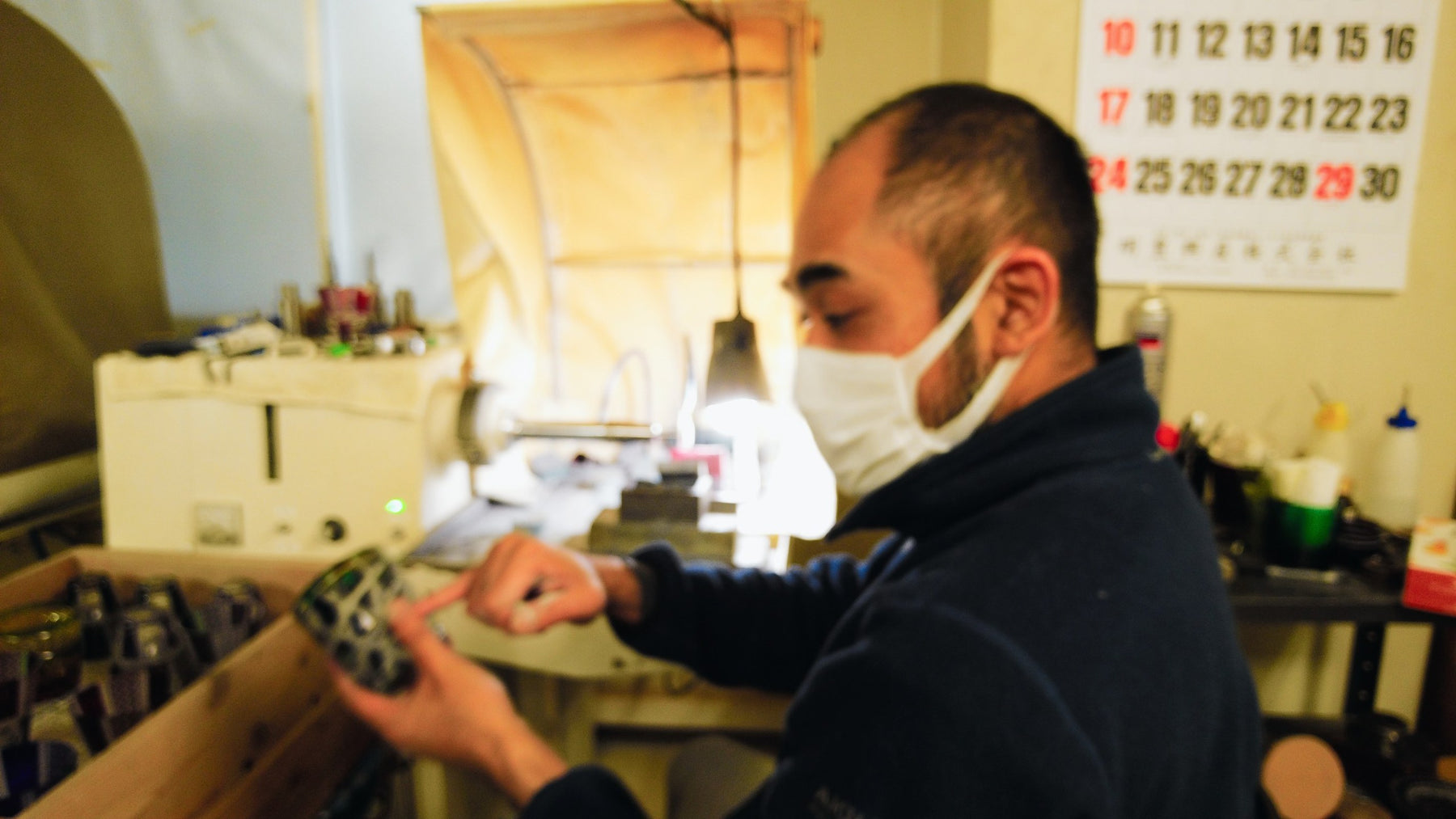 Craftsman inspecting a cut-glass blank at Rinzen Tokyo Glass Studio, 8 April 2022
