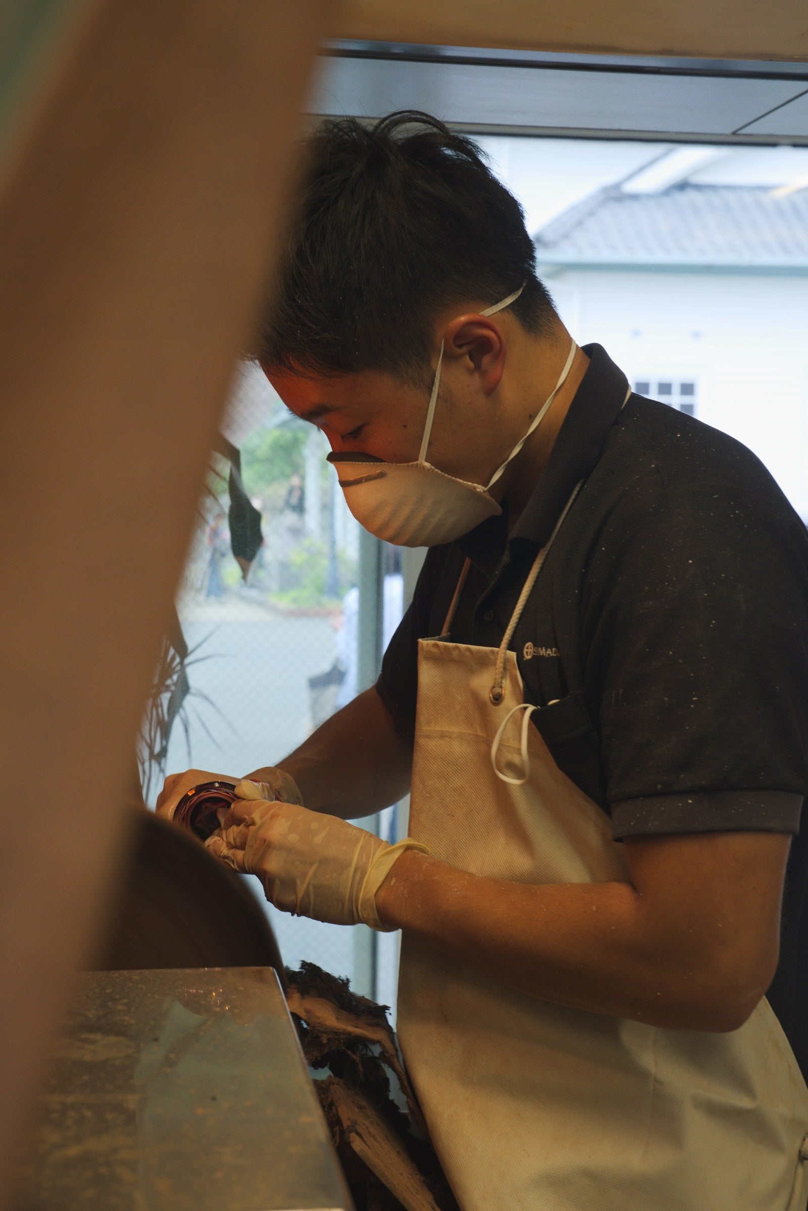 Craftsman polishing a cut-glass piece at the bench